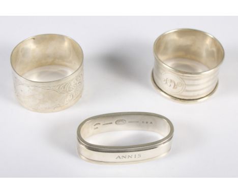 A Georg Jensen silver napkin ring, inscribed "Annis", 1.2oz approx, and two silver napkin rings, 1.1oz approx