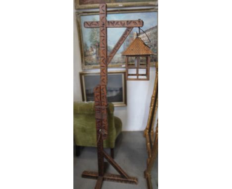 An adjustable carved oak standard lamp