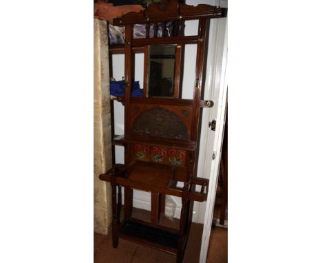 A late 19th Century hall stand, the back decorated bevelled mirror and tile panel, 33" wide