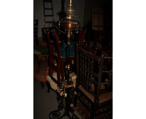 A wrought iron standard lamp with copper oil lamp fitting (now converted to electricity)