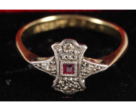 An 18ct gold ruby set ring and three silver rings