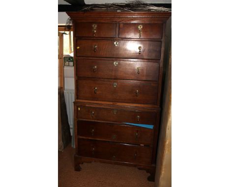 A 19th Century oak chest on chest of two short and six long drawers with replacement brass drop handles, on bracket supports,