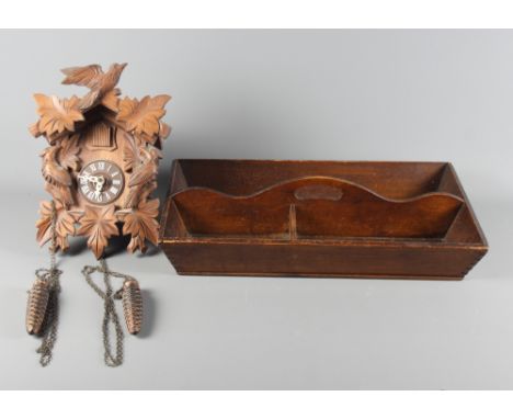 A 19th Century wooden cutlery tray and a 20th Century Black Forest cuckoo clock