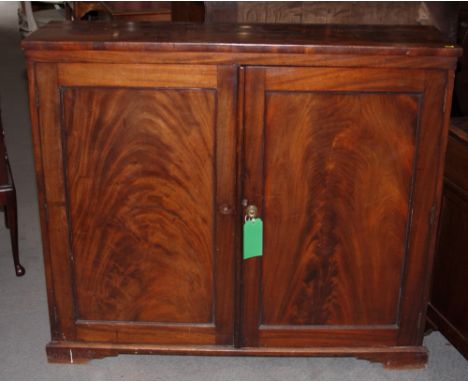 A 19th Century hall cupboard enclosed two doors with figured panels, on bracket supports, 46 1/2" wide x 40" high