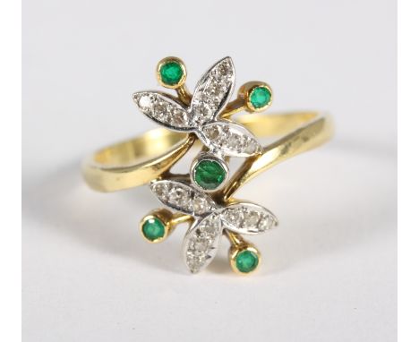 An 18ct gold floral design ring set diamonds and emeralds