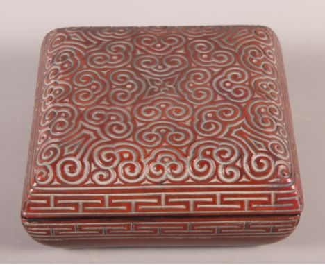 A Chinese carved cinnabar lacquer square box with scroll decoration, 7 1/2" wide