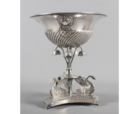 A continental white metal tazza, on swan decorated base, and a continental white metal spoon, a silver plated toast rack and 
