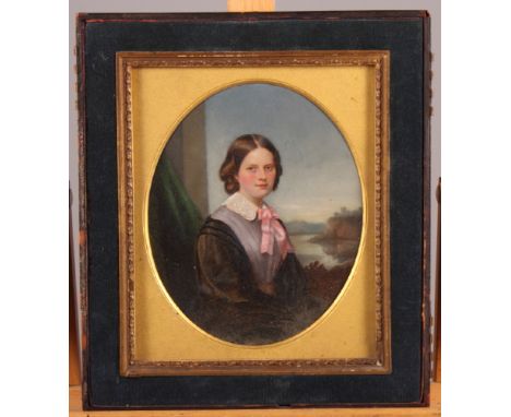 A 19th Century oval miniature, portrait of a lady seated by a window, 6" x 5", in velvet faced leather travelling case (incom
