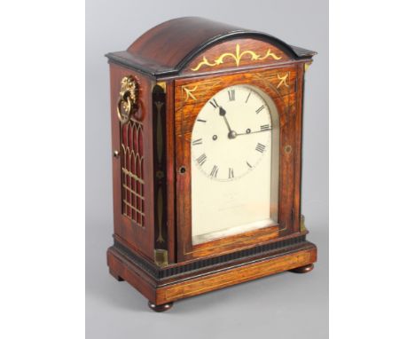 An early 19th Century rosewood and brass inlaid bracket clock by Fletcher with twin fusee movement, 16" high