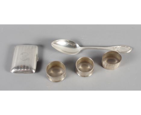 A silver cigarette case, three silver napkin rings and a continental .800 grade silver serving spoon, 7.5oz troy approx