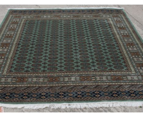 A Bokhara design carpet, green ground decorated rows of flattened guls, numerous border stripes, 108" x 79" approx