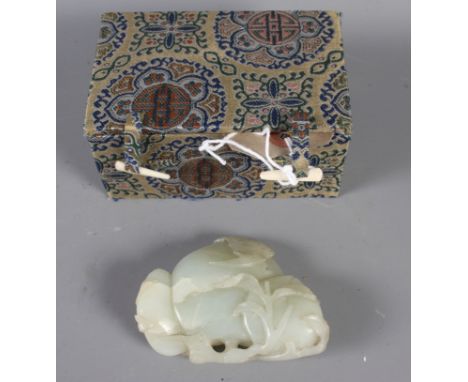 A Chinese pale celadon jade carving of three peaches and a bat, 2 1/4" x 3", in fitted silk lined box