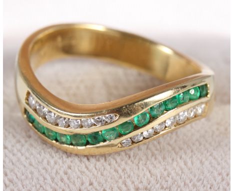 An 18ct gold ring set emeralds and diamonds, size P