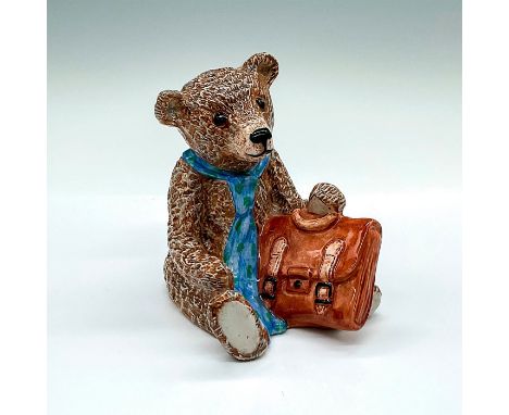 Teddy bear figure for Compton and Woodhouse. Brown and gray glaze bear with a green spotted blue tie, holding a brown bag. Ro