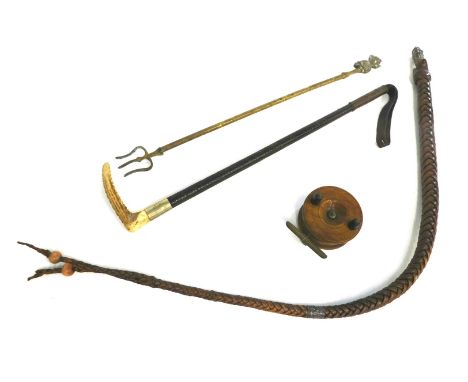 A continental whip, with white metal mounts, a leather riding crop, Lincoln Imp toasting fork, and a mahogany fishing reel. 