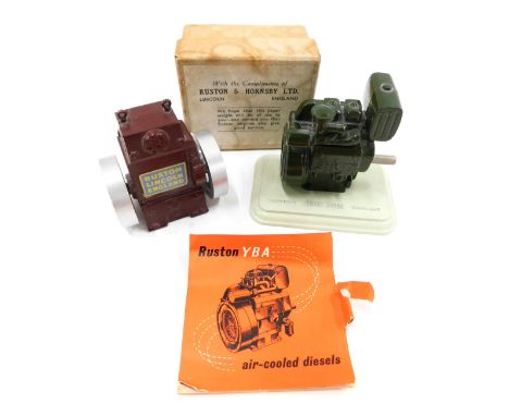 Two Ruston and Hornsby Limited paperweights, each modelled in the form of an engine, one boxed, 8cm wide. 