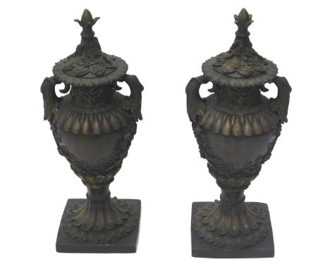 A pair of bronze two handled urns and covers, each cast with acanthus, grapes and vines, etc., on fluted column and square ba