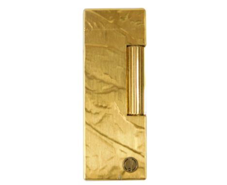 A Dunhill gold plated lighter, with engine turned and textured finish, emblem to front, 6.5cm long. 