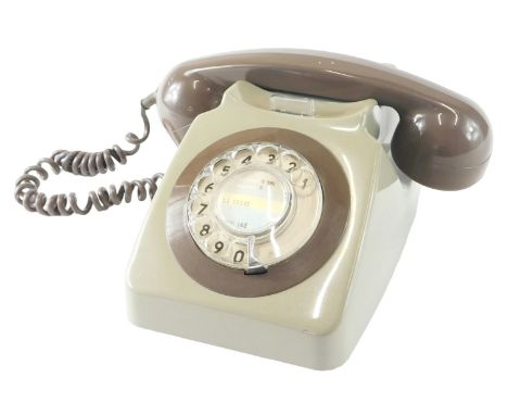 A two tone brown vintage plastic telephone.