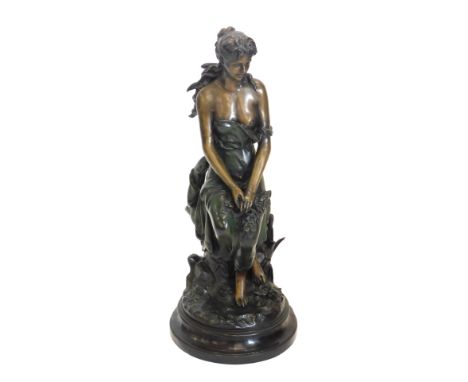 After Augustus Moreau. Bronze and green painted figure of a seated lady, on a domed oval base, 78cm high. 