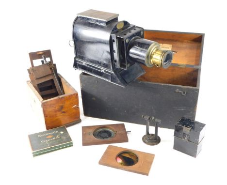 A Victorian ebonised tin plate magic lantern, and some slides to include some with moving parts.