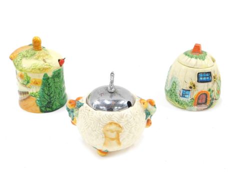 A Clarice Cliff Celtic Harvest relief moulded preserve jar, with chrome plated cover and a Cottageware preserve jar, and a Ja