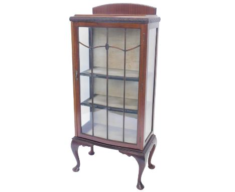 A mahogany display cabinet, the bow fronted top with a raised back above a glazed door enclosing fabric lined interior, on ca