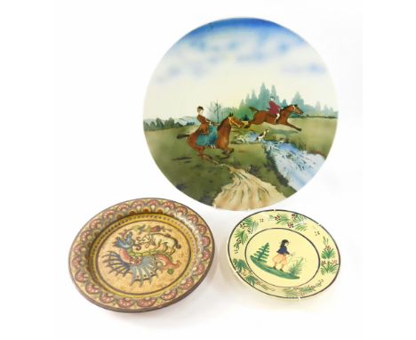 A Continental ceramic plaque, decorated with hunting scene, 38cm wide, a Quimper plate, and an Italian sgraffito decorated di
