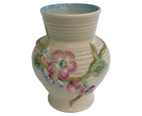 A Clarice Cliff ceramic vase, decorated in relief with flowers, 18cm high.