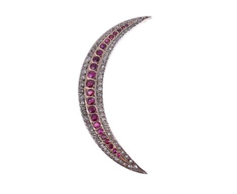 
	
		A DIAMOND AND RUBY CRESCENT BROOCH
		The crescent with a central row of graduated circular cut rubies, with old cut and 