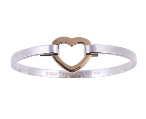 
	
		TIFFANY &amp; CO., A TWO COLOUR SPRUNG HEART BANGLE 
		CIRCA 2003
		The polished silver coloured bangle to a gold colour