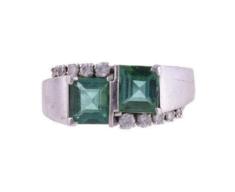 
	
		A GREEN TOURMALINE AND DIAMOND DRESS RING
		The step cut tourmalines with crossover brilliant cut diamond accents, appro