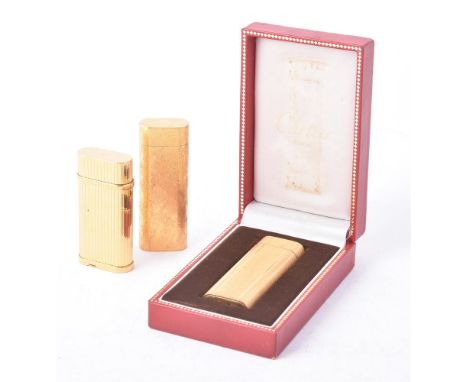 
	
		CARTIER, THREE GOLD PLATED GAS LIGHTERS 
		LATE 20TH CENTURY 
		With a textured finish, vertical grooved and waved engin
