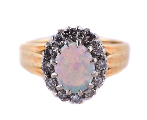 
	
		AN OPAL AND DIAMOND CLUSTER RING 
		LONDON 1970
		The oval cabochon opal within a surround of eight cut diamonds, approx