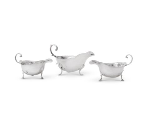 
	
		A PAIR OF SILVER OVAL SAUCE BOATS 
		ASPREY &amp; CO., LONDON 1931 
		With flying C-scroll handles, shaped rims and step