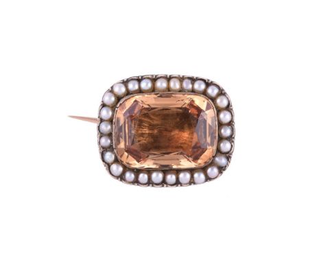 
	
		A GEORGE III GOLDEN TOPAZ AND SEED PEARL CLUSTER BROOCH 
		CIRCA 1810
		The step cut topaz with canted corners in a clos
