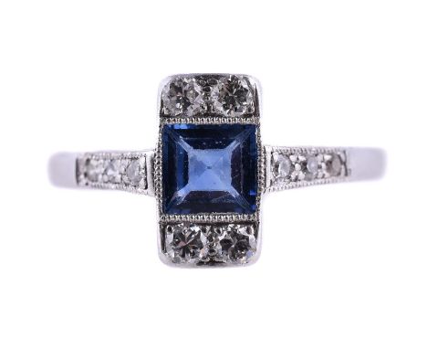 
	
		A 1930S SAPPHIRE AND DIAMOND PANEL RING
		The step cut sapphire within a millegrained surround with two pairs of brillia