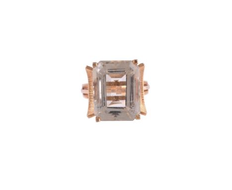 
	
		A 1960S CITRINE DRESS RING
		The step cut citrine with canted corners, above curved reeded shoulders, indistinct contine
