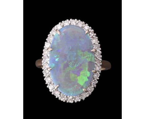 
	
		AN OPAL AND DIAMOND CLUSTER RING
		The polished oval opal panel within a surround of eight cut diamonds, approximately 0