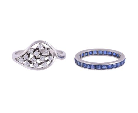 
	
		A SAPPHIRE ETERNITY RING AND A DIAMOND DRESS RING
		The step cut sapphires in a channel setting; the second ring set wit