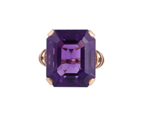 
	
		A 1960S AMETHYST DRESS RING
		The step cut amethyst with canted corners, with wire decorated shoulders
		SIZE/DIMENSIONS
