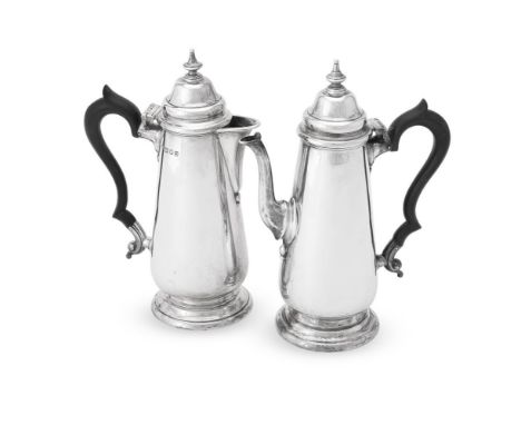 
	
		A MATCHED PAIR OF SILVER CAFÉ AU LAIT POTS  
		THOMAS BRADBURY &amp; SONS, SHEFFIELD 1936 AND LONDON 1937 
		With spire 