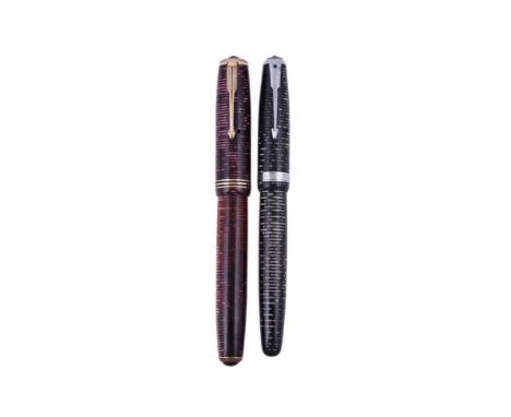 
	
		PARKER, VACUMATIC, TWO VINTAGE FOUNTAIN PENS
		Cap and barrel:  First, Maxima, burgundy pearl, inked; second, Blue Diamo