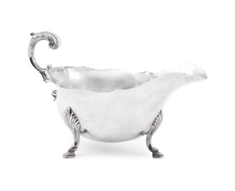 
	
		A SILVER OVAL SAUCE BOAT 
		ATKIN BROS, SHEFFIELD 1932 
		With a leaf-capped flying scroll handle, a shaped rim and on s