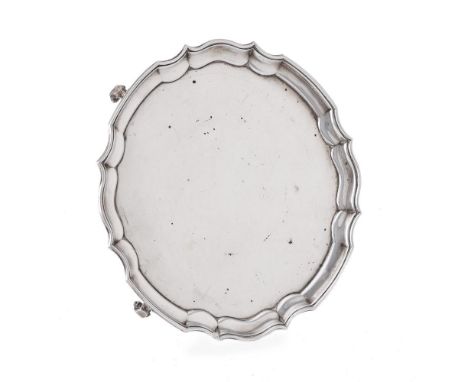 
	
		A SILVER SHAPED CIRCULAR SALVER 
		JAMES DEAKIN &amp; SONS, SHEFFIELD 1933 
		With a raised moulded rim, on three scroll