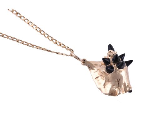 
	
		Y&nbsp;A BLACK CORAL AND GOLD COLOURED CONCH SHELL PENDANT
		The conch shell with black coral spikes and inner section, 