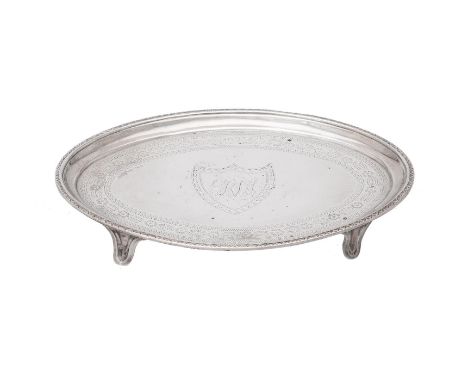 A GEORGE III SILVER SHAPED OVAL TEA POT STAND 
CHARLES ALDRIDGE, LONDON 1787 
With engraved decorative bands and a monogram w