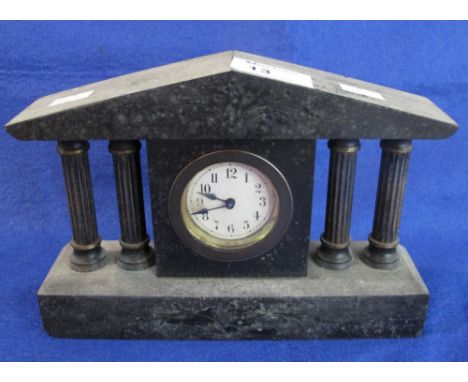 Small black slate architectural mantel clock with back winding movement.