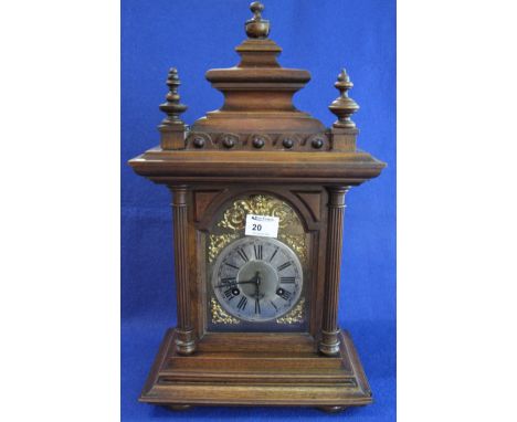Early 20th Century German two train oak architectural mantel clock with brass face and silvered Roman chapter ring.