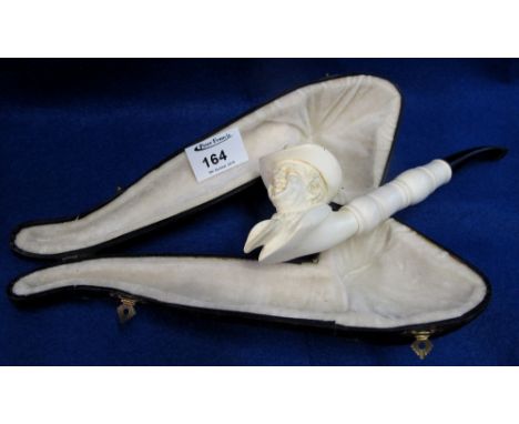 Large cased Meerschaum portrait smoking pipe depicting an American Cowboy figure and having ebony stem.